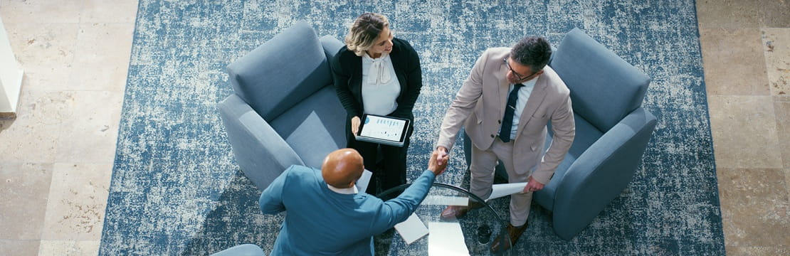 Business owners and advisors meet to discuss growth strategies, highlighting how Qualified Small Business Stock (QSBS) can provide significant tax exemptions and incentives that support long-term business expansion and value creation.