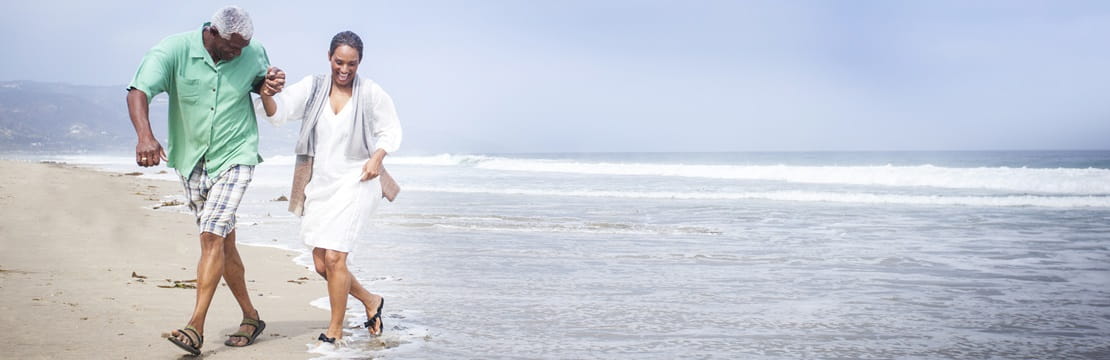 Mature couple having fun on the beach